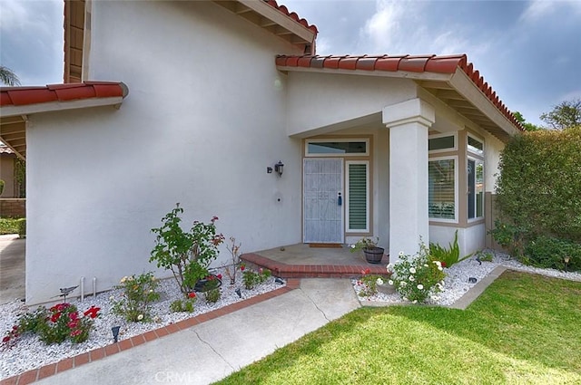 24650 Via Melinda, Yorba Linda, CA 92887 - property entrance with stucco siding, a tile roof, and a yard