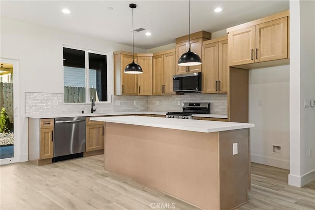 5399 Hickory Way, Paradise, CA 95969 - kitchen with stainless steel appliances, a kitchen island, light wood-type flooring, backsplash, and recessed lighting