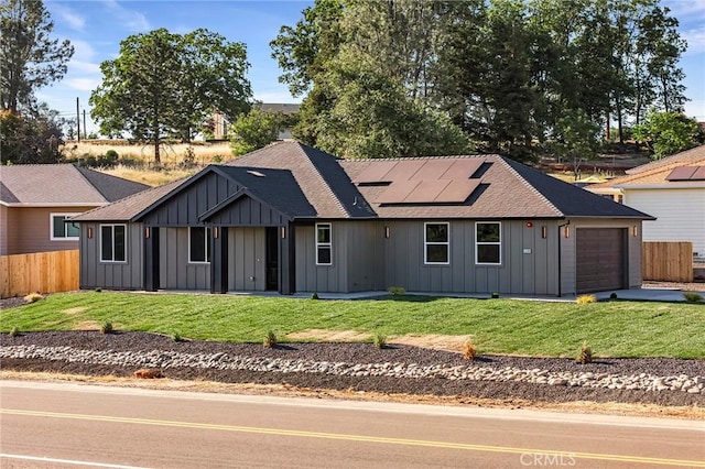 5399 Hickory Way, Paradise, CA 95969 - view of front facade featuring board and batten siding, solar panels, a shingled roof, a garage, and driveway