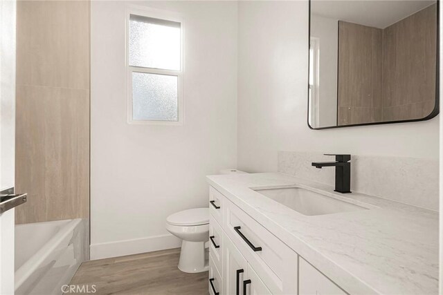 5399 Hickory Way, Paradise, CA 95969 - bathroom featuring vanity, toilet, wood finished floors, and baseboards