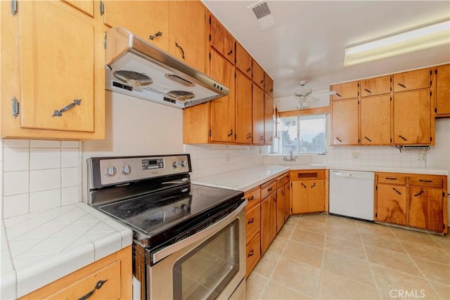 7236 Hellman Ave, Rancho Cucamonga, CA 91701 - kitchen featuring white dishwasher, stainless steel electric range, extractor fan, backsplash, and tile countertops