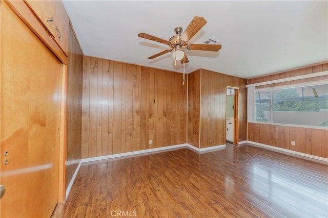 7236 Hellman Ave, Rancho Cucamonga, CA 91701 - empty room featuring wood finished floors, a ceiling fan, wood walls, and baseboards