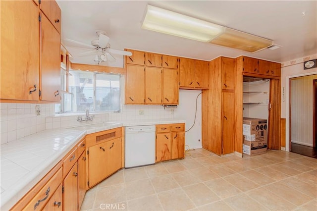 7236 Hellman Ave, Rancho Cucamonga, CA 91701 - kitchen with white dishwasher, tile countertops, a sink, and tasteful backsplash
