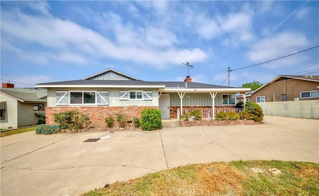 7236 Hellman Ave, Rancho Cucamonga, CA 91701 - view of front of house featuring covered porch, brick siding, and a chimney
