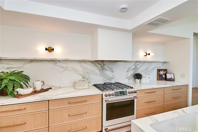 9539 Gladbeck Ave, Northridge, CA 91324 - kitchen with range with gas stovetop, tasteful backsplash, light stone counters, and light brown cabinetry