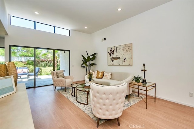 9539 Gladbeck Ave, Northridge, CA 91324 - living area with light wood-type flooring, a towering ceiling, recessed lighting, and baseboards