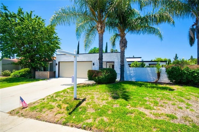 9539 Gladbeck Ave, Northridge, CA 91324 - view of front of house featuring stucco siding, concrete driveway, a garage, and a front lawn