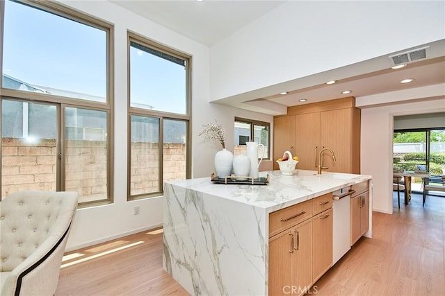 9539 Gladbeck Ave, Northridge, CA 91324 - kitchen with a sink, light wood-type flooring, light stone counters, an island with sink, and recessed lighting