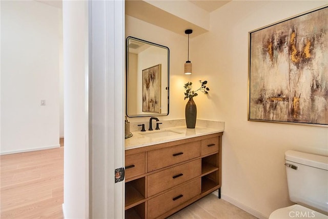 9539 Gladbeck Ave, Northridge, CA 91324 - bathroom with vanity, toilet, baseboards, and wood finished floors