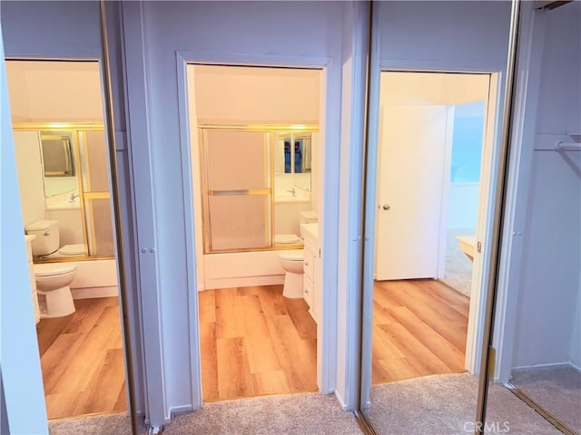 1404 N Tustin Ave Unit H1, Santa Ana, CA 92705 - bathroom with wood finished floors and bath / shower combo with glass door