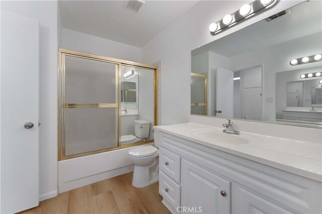 1404 N Tustin Ave Unit H1, Santa Ana, CA 92705 - full bathroom with wood finished floors, vanity, and bath / shower combo with glass door