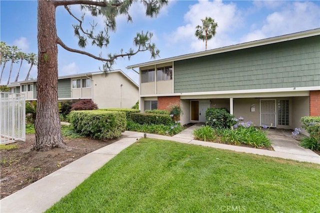 1404 N Tustin Ave Unit H1, Santa Ana, CA 92705 - view of front of house featuring stucco siding and brick siding