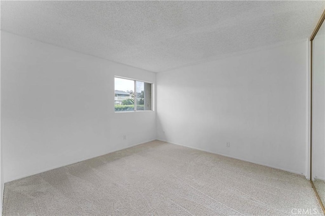 1404 N Tustin Ave Unit H1, Santa Ana, CA 92705 - unfurnished room featuring light carpet and a textured ceiling