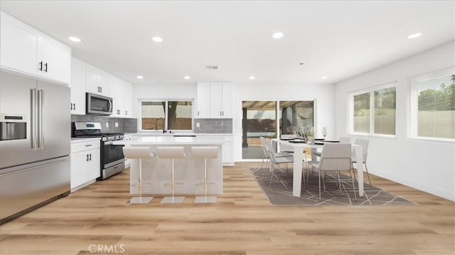 1208 Del Haven Ct, Redlands, CA 92374 - kitchen with stainless steel appliances, healthy amount of natural light, light wood-style floors, a center island, and recessed lighting