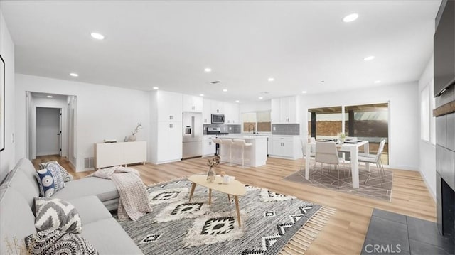 1208 Del Haven Ct, Redlands, CA 92374 - living room featuring plenty of natural light, light wood-type flooring, and recessed lighting