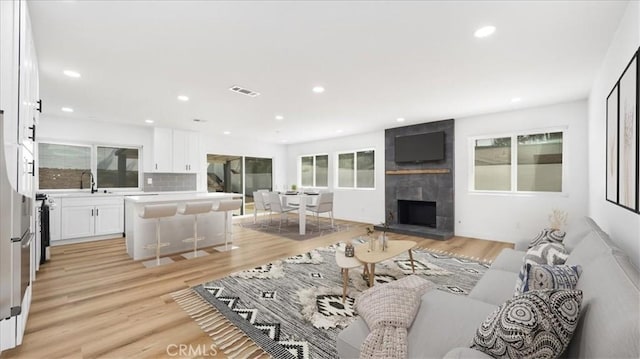 1208 Del Haven Ct, Redlands, CA 92374 - living area featuring light wood finished floors, a fireplace, and recessed lighting
