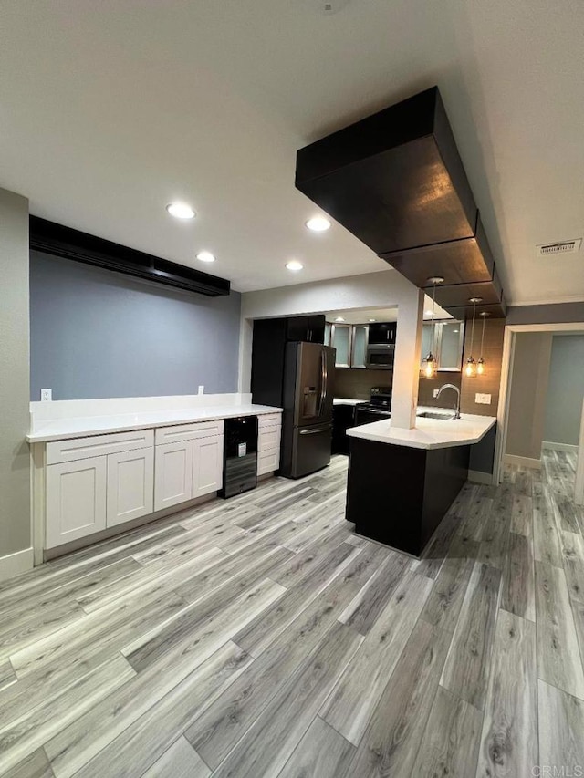 3078 Broadway Unit 107, San Diego, CA 92102 - kitchen with stainless steel appliances, a sink, light wood finished floors, light countertops, and recessed lighting