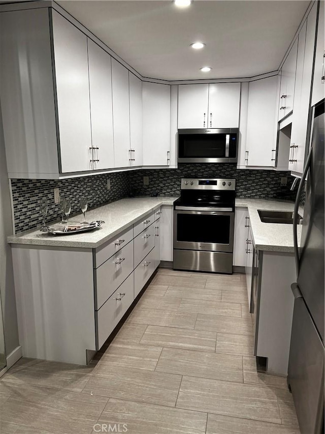 6330 Genesee Ave Unit 103, San Diego, CA 92122 - kitchen with stainless steel appliances, decorative backsplash, light countertops, light wood-style flooring, and recessed lighting