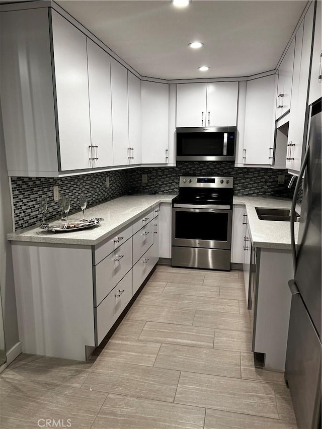 6330 Genesee Ave Unit 103, San Diego, CA 92122 - kitchen featuring stainless steel appliances, decorative backsplash, light countertops, light wood finished floors, and recessed lighting
