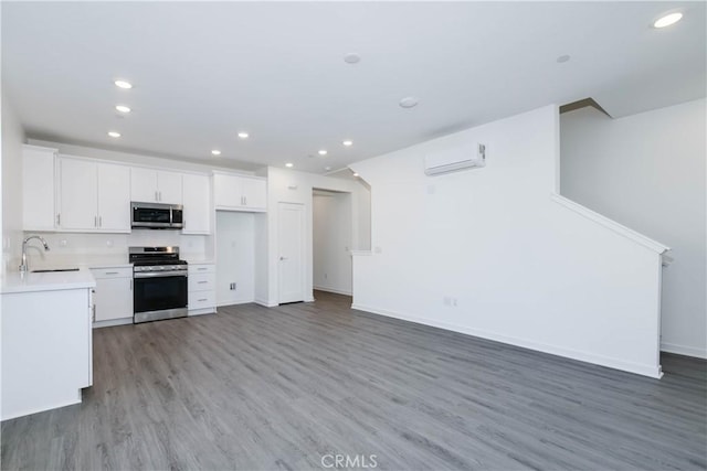 667 Limoncello Ln, Covina, CA 91723 - kitchen with appliances with stainless steel finishes, a sink, recessed lighting, light wood-style flooring, and white cabinets