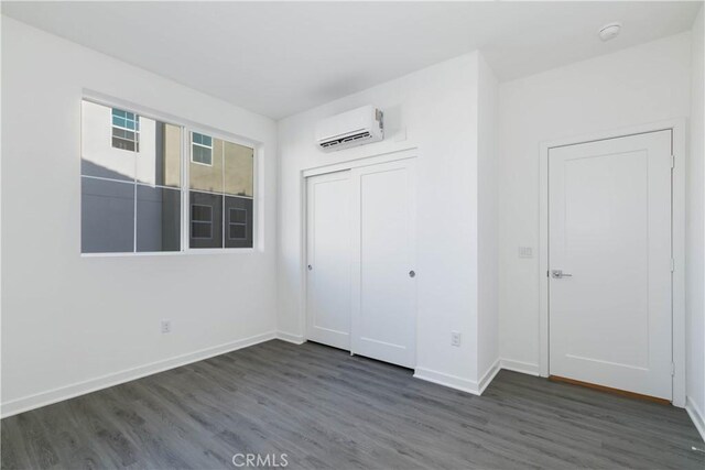 667 Limoncello Ln, Covina, CA 91723 - unfurnished bedroom with an AC wall unit, wood finished floors, baseboards, and a closet
