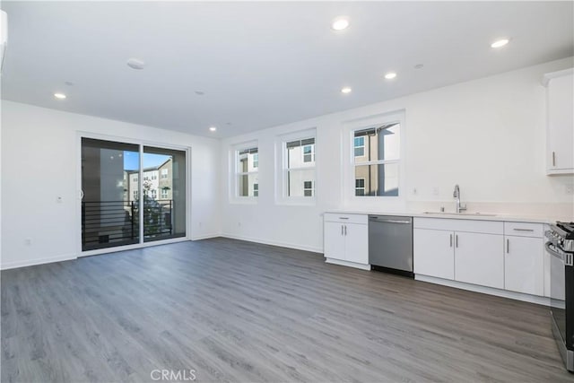667 Limoncello Ln, Covina, CA 91723 - kitchen featuring dishwasher, a sink, wood finished floors, white cabinets, and recessed lighting