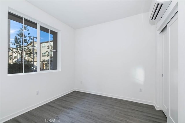 667 Limoncello Ln, Covina, CA 91723 - spare room with a wall mounted AC, dark wood-type flooring, and baseboards