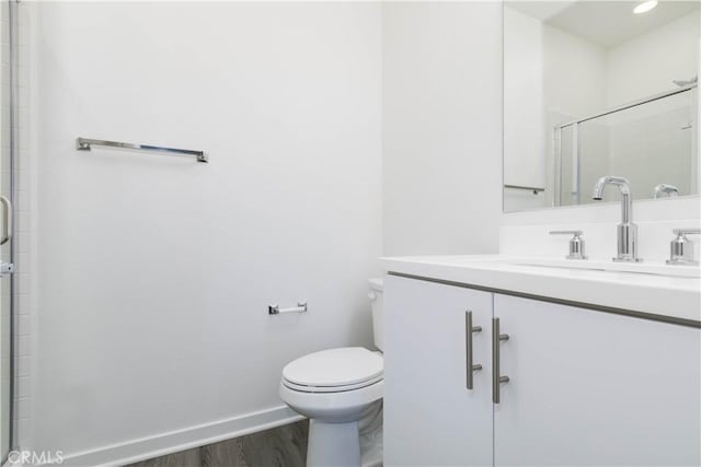 667 Limoncello Ln, Covina, CA 91723 - full bathroom with wood finished floors, vanity, toilet, baseboards, and a tile shower