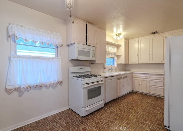 124 Mauna Loa Dr, Monrovia, CA 91016 - kitchen with white appliances, white cabinets, brick patterned floors, and light countertops