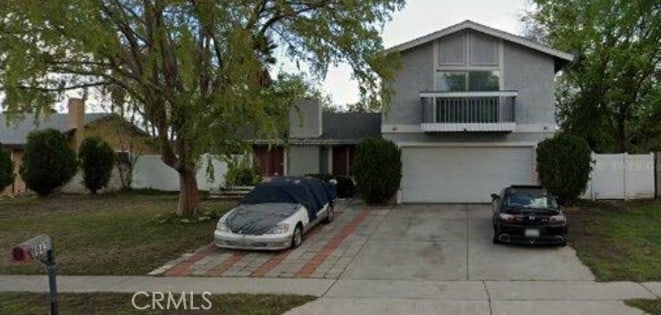 943 W Valencia St, Rialto, CA 92376 - view of front of home featuring driveway and stucco siding