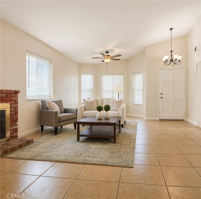 13941 Parkwood Dr, Fontana, CA 92337 - living area with light tile patterned flooring, a chandelier, ceiling fan, and a brick fireplace