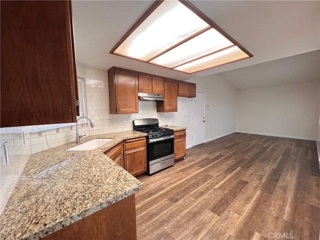 13941 Parkwood Dr, Fontana, CA 92337 - kitchen featuring stainless steel gas range oven, under cabinet range hood, decorative backsplash, and brown cabinets