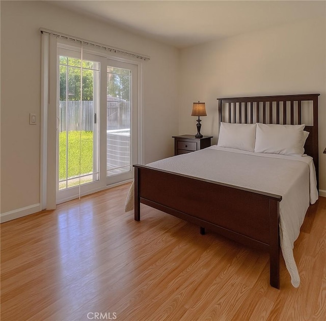 13941 Parkwood Dr, Fontana, CA 92337 - bedroom with access to exterior and light wood-type flooring