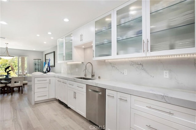 24336 Hillview Dr, Laguna Niguel, CA 92677 - kitchen featuring a sink, stainless steel dishwasher, light wood-style flooring, white cabinets, and decorative backsplash