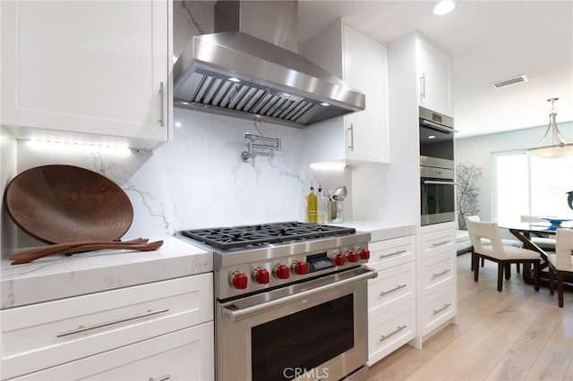 24336 Hillview Dr, Laguna Niguel, CA 92677 - kitchen with appliances with stainless steel finishes, wall chimney range hood, white cabinetry, decorative backsplash, and light countertops
