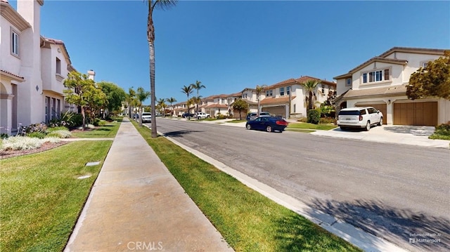 4312 Waterside Ln, Oxnard, CA 93035 - view of asphalt road with a residential view, sidewalks, and curbs