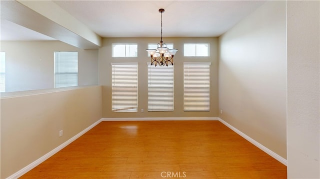 4312 Waterside Ln, Oxnard, CA 93035 - unfurnished dining area featuring a chandelier, light wood finished floors, healthy amount of natural light, and baseboards