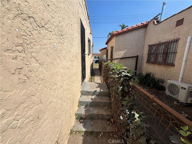 1434 W 92nd St, Los Angeles, CA 90047 - view of side of property with ac unit, stucco siding, and a tiled roof