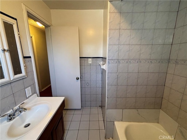 1434 W 92nd St, Los Angeles, CA 90047 - full bathroom featuring tile walls, vanity, tile patterned flooring, and a wainscoted wall