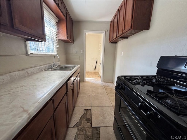 1434 W 92nd St, Los Angeles, CA 90047 - kitchen with black range with gas stovetop, a sink, and light countertops