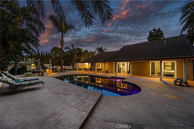 17927 Sun Hill Dr, Yorba Linda, CA 92886 - pool at dusk featuring a hot tub, an outdoor pool, and a patio area