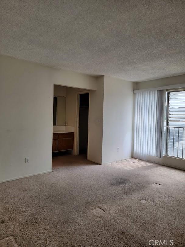 1582 Mitchell Ave, Tustin, CA 92780 - carpeted empty room featuring a textured ceiling
