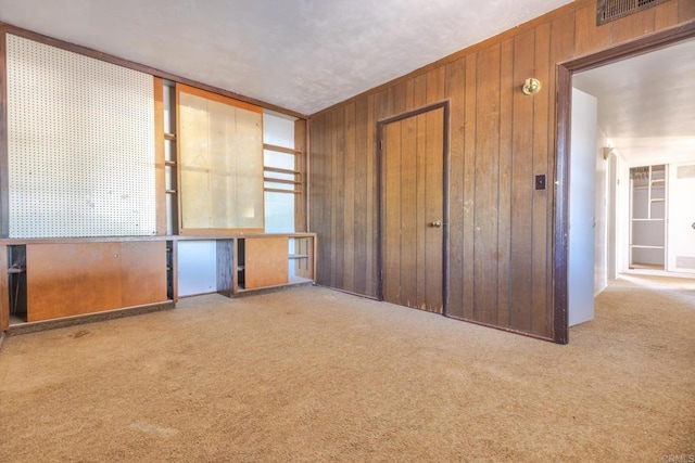 630 N Palm Dr, Brawley, CA 92227 - unfurnished bedroom featuring carpet floors, wooden walls, and a closet