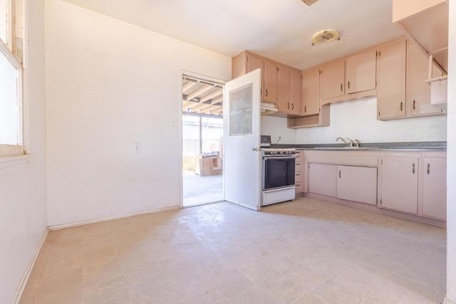 630 N Palm Dr, Brawley, CA 92227 - kitchen featuring white range and cream cabinets