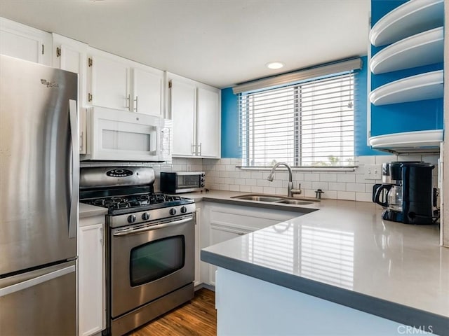 1617 Ramona, Grover Beach, CA 93433 - kitchen featuring stainless steel appliances, a sink, white cabinetry, and backsplash