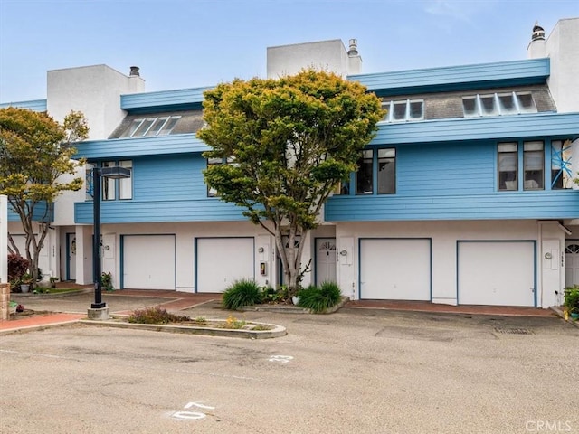 1617 Ramona, Grover Beach, CA 93433 - view of front facade with a garage, a chimney, and stucco siding