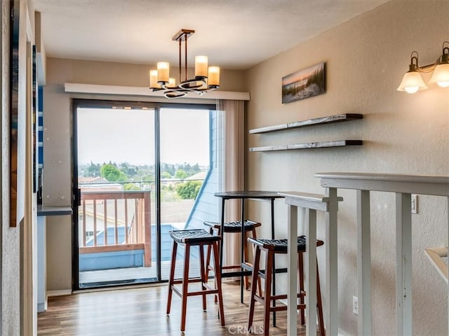 1617 Ramona, Grover Beach, CA 93433 - dining space with wood finished floors, a chandelier, and a textured wall