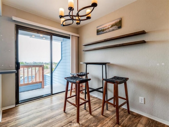 1617 Ramona, Grover Beach, CA 93433 - dining space with a chandelier, wood finished floors, baseboards, and a textured wall