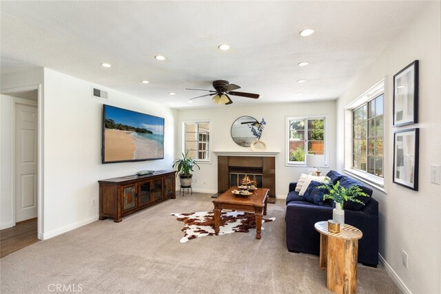 1188 Old Hickory Rd, Corona, CA 92882 - living room featuring a ceiling fan, a glass covered fireplace, light carpet, and recessed lighting