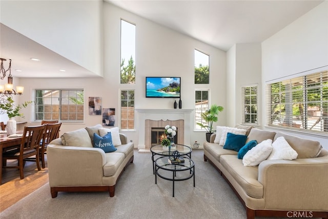 1188 Old Hickory Rd, Corona, CA 92882 - living area with a towering ceiling, healthy amount of natural light, a chandelier, a fireplace, and wood finished floors